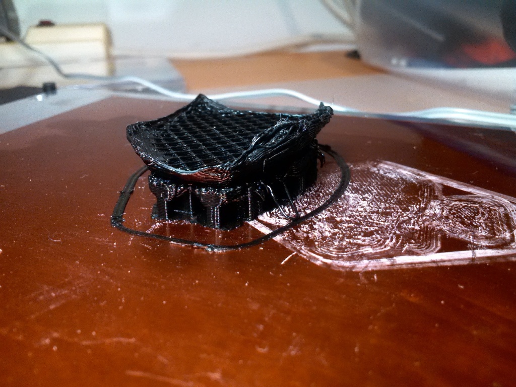 An aborted attempt at printing the remote caddy piece.  Note the curled up edges and numerous print failures