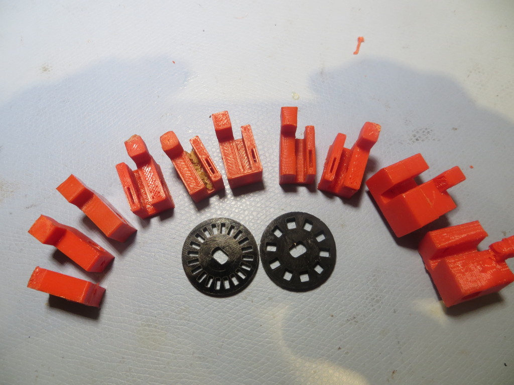 Evolution of an IR tach sensor bracket, along with the original and a custom-printed tach wheel