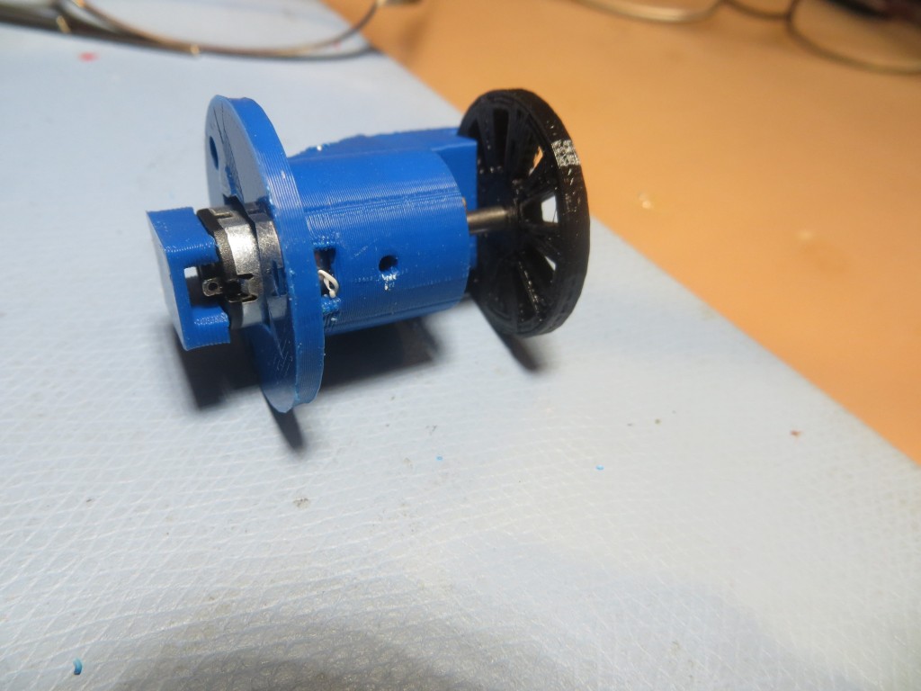 Miniature DC motor mount, with tach sensor attachment, side view showing motor contact cover